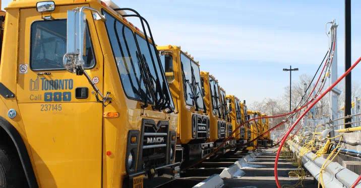 A line of City of Toronto trucks being refuelled at a compressed natural gas station. 