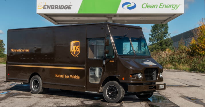 UPS delivery truck is parked below an compressed natural gas fueling station with the Enbridge and Clean Energy logos.