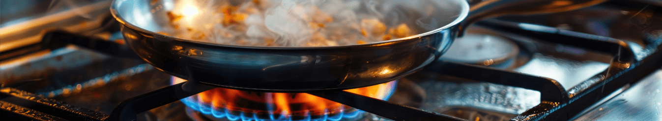 Cooking with a stainless steel pan on a gas stove