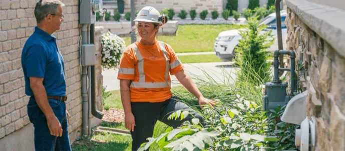 Enbridge Gas Inc. gas technician at work and engaging with a customer