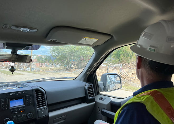 Enbridge Gas Employee in Work Truck Surveying Damage