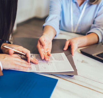 Young couple signing a contract in a office