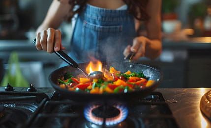 Girl cooking on gas stove