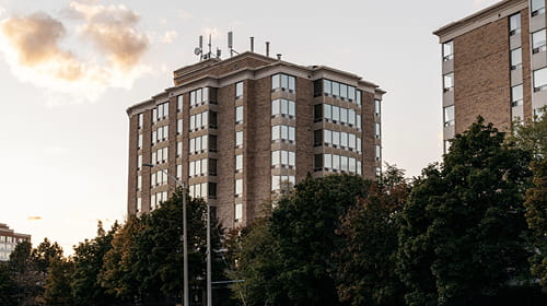 Large brown condominium building.