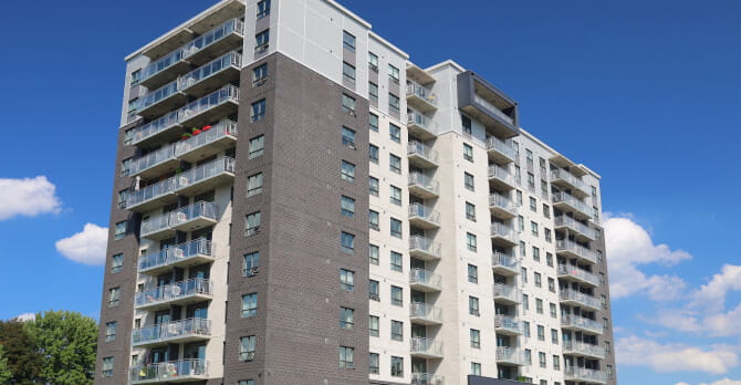 Exterior of large grey condominium