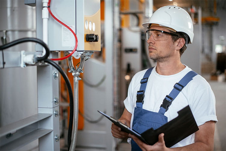 Man with hard hat looking at equipment