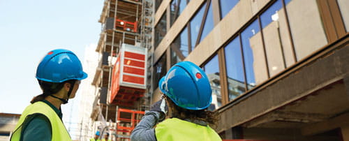 Workers looking at a buiilding