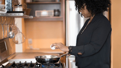 Woman cooking natural gas stove