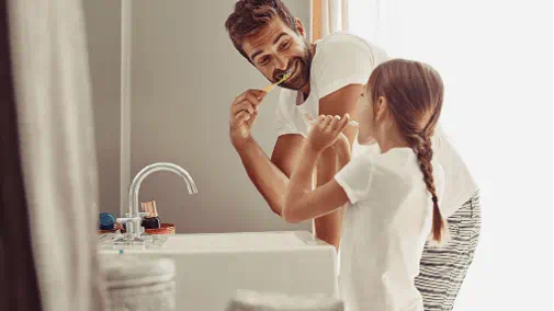 Family brushing teeth heated water