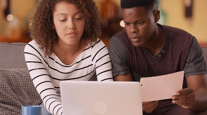 Two people looking at a laptop computer