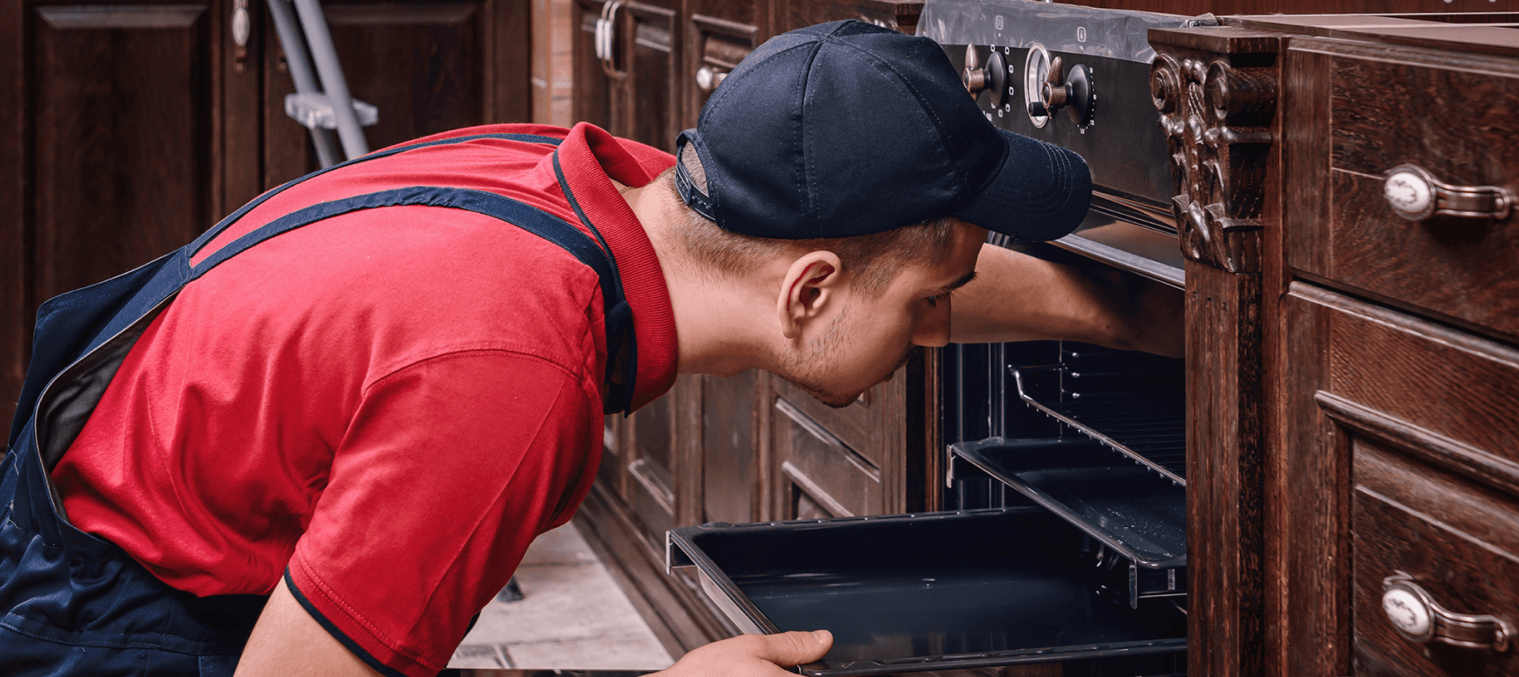 A professional installer overseeing an oven installation