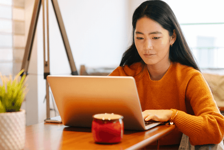 Young woman surfing on her laptop at home