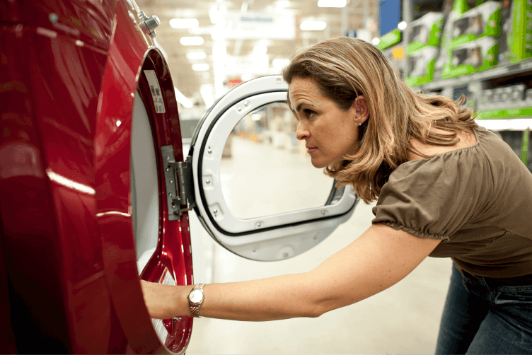 Woman inspecting a washer and dryer at a store