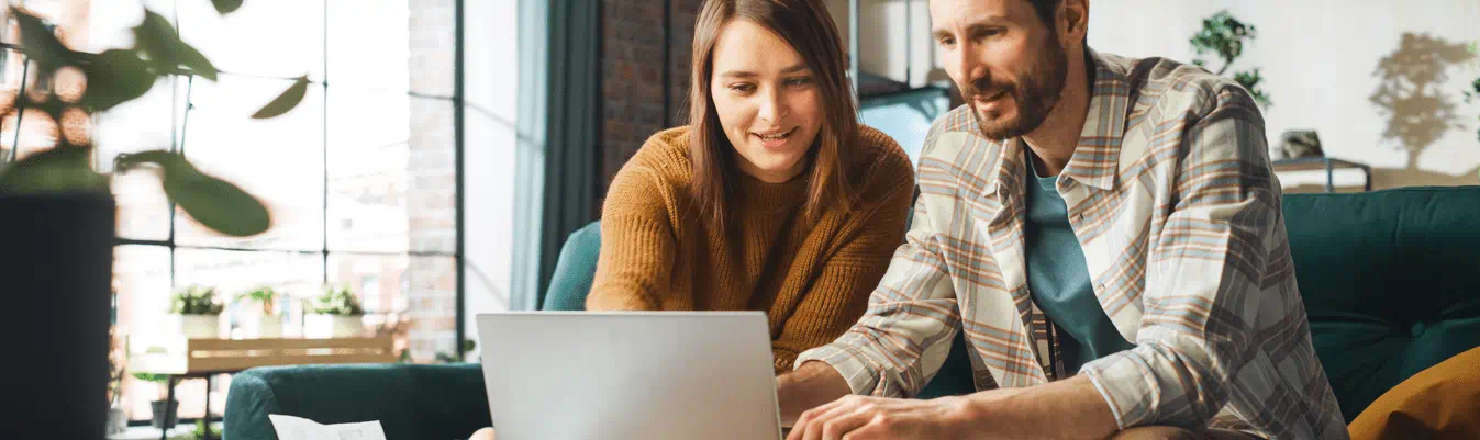 Two people looking at a computer